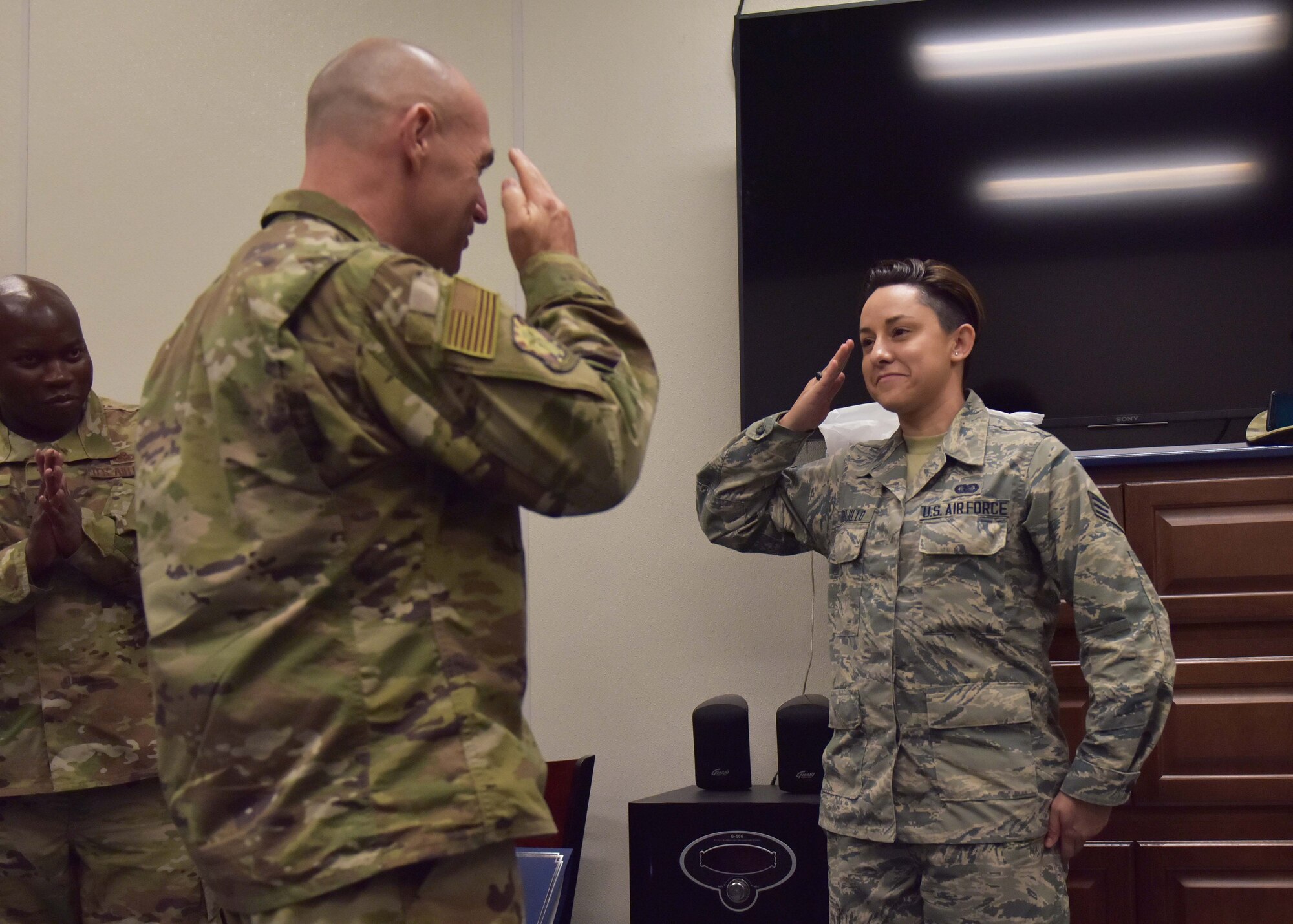 Senior Airman Gina Trujillo, 944th Logistics Readiness Squadron administration helper, salutes Col. James Greenwald, 944th Fighter Wing commander, August 4 during a unit training assembly at Luke Air Force Base, Ariz. (U.S. Air Force photo by Tech. Sgt. Louis Vega Jr.)