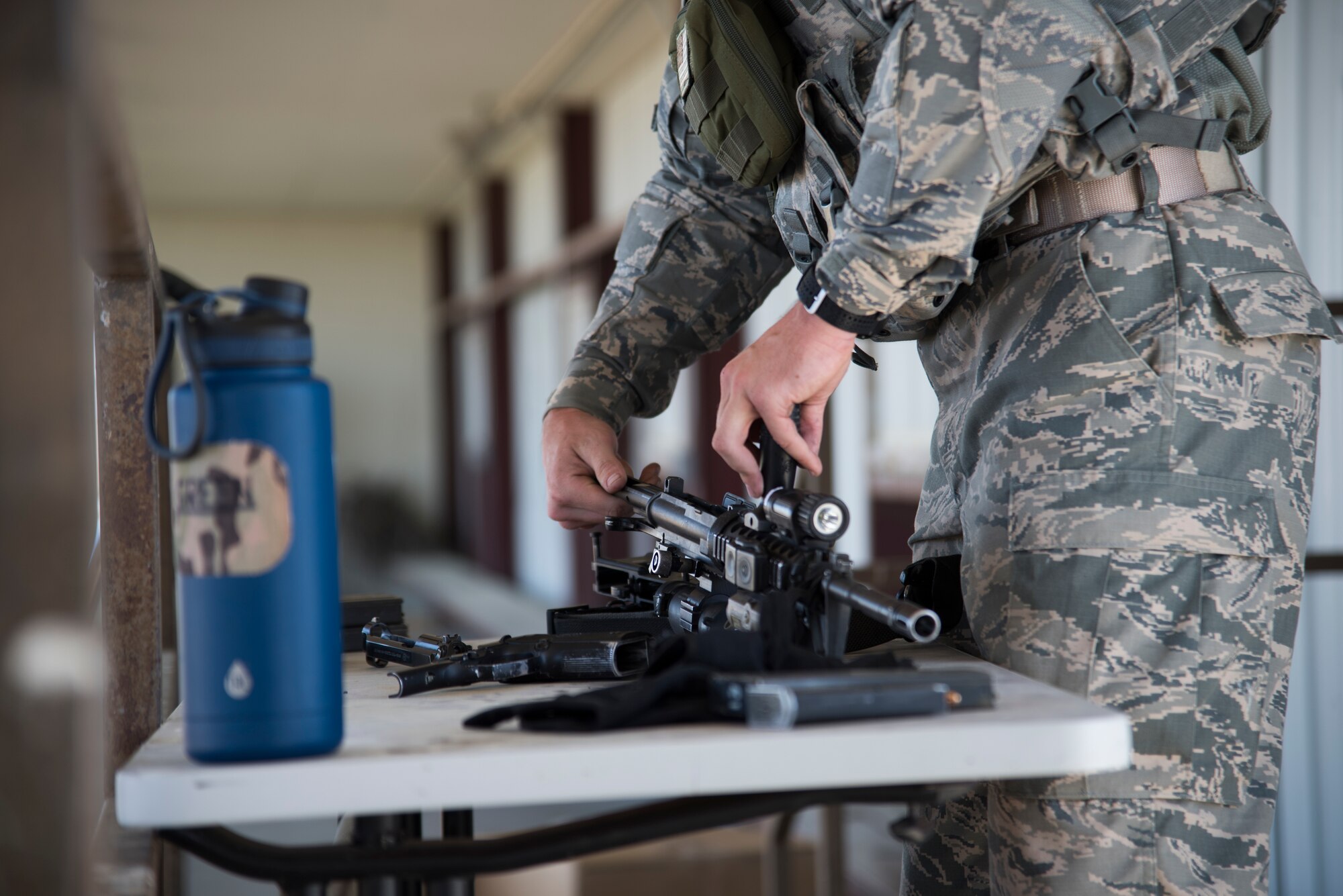 U.S. Air Force A1C Jesse Antal, 366th Security Forces Squadron response force member, assembles a M4A1 carbine August 16, 2019, at the off-base small arms range near Mountain Home Air Force Base, Idaho. Assembling the M4A1 carbine is a requirement to join the EST. (U.S. Air Force photo by Airman Natalie Rubenak)