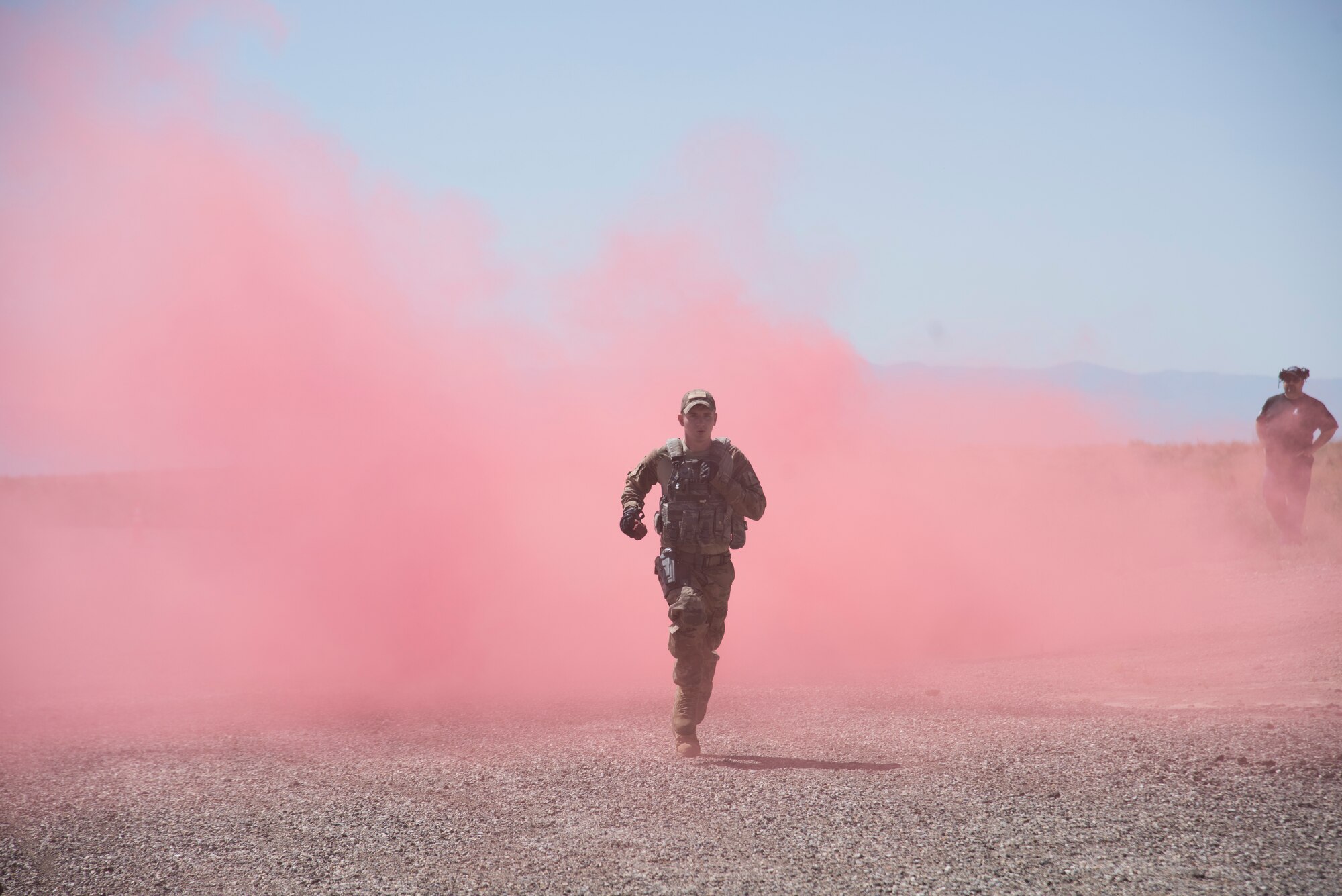 U.S. Air Force A1C Jacob Bailey, 366th Security Forces Squadron response force leader, runs through a smoke bomb August 16, 2019, at the off-base small arms range near Mountain Home Air Force Base, Idaho. The candidates ran four 50-meter runs through the smoke. (U.S. Air Force photo by Airman Natalie Rubenak)