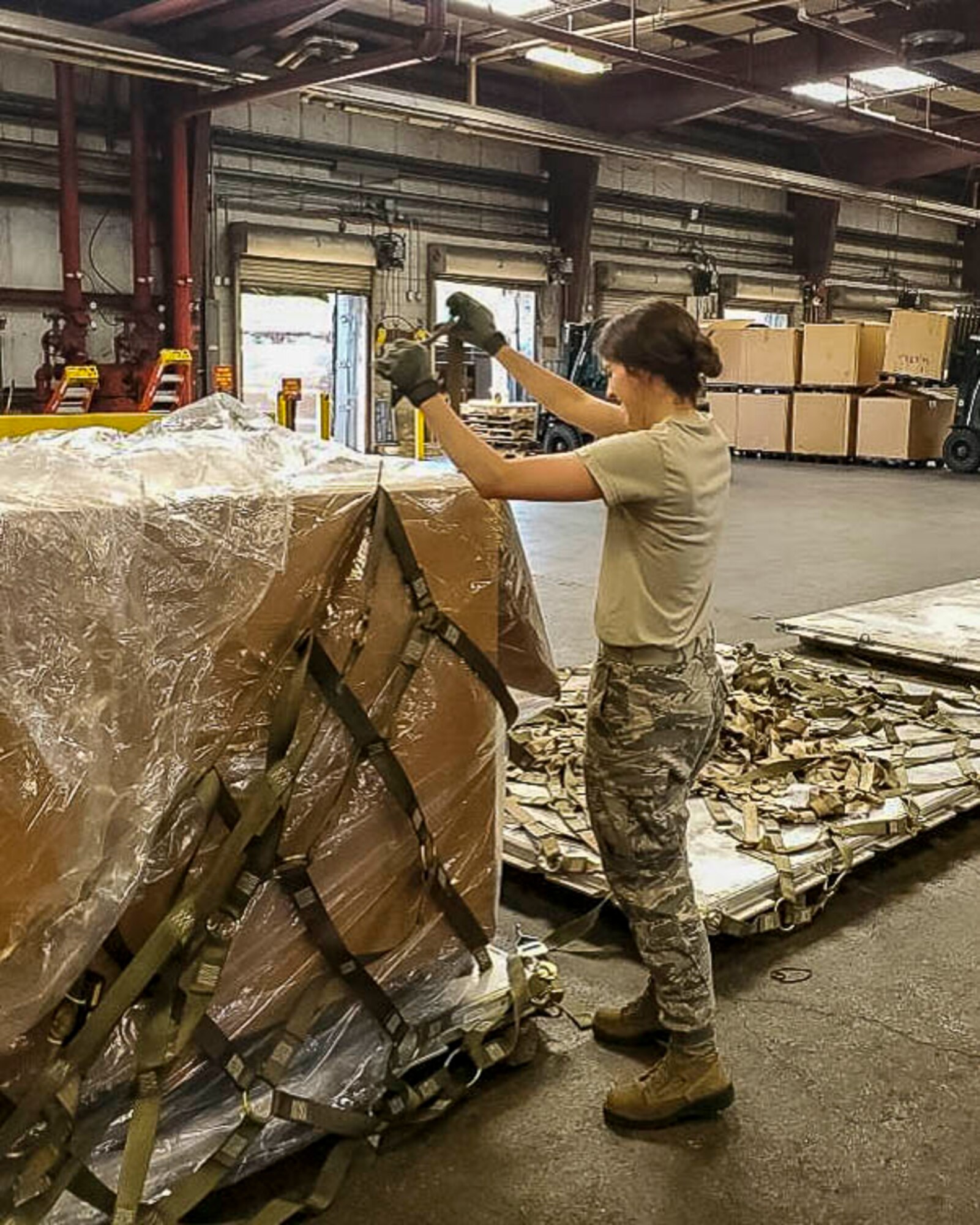 Senior Airman Hannah Gillespie, 96th Aerial Port Squadron air transportation specialist, prepares and palletizes cargo for shipment on June 30, 2018 at Norfolk, Va.  •	The majority of our Reserve members have to meet the same requirements of Active Duty personnel. This means they have to balance a fulltime civilian job or college studies while maintaining their military readiness. Traditional Reservists have one weekend a month, two weeks a year to fulfill training in order to prepare for real world missions and requirements, ensuring strategic depth and readiness. (Courtesy photo)