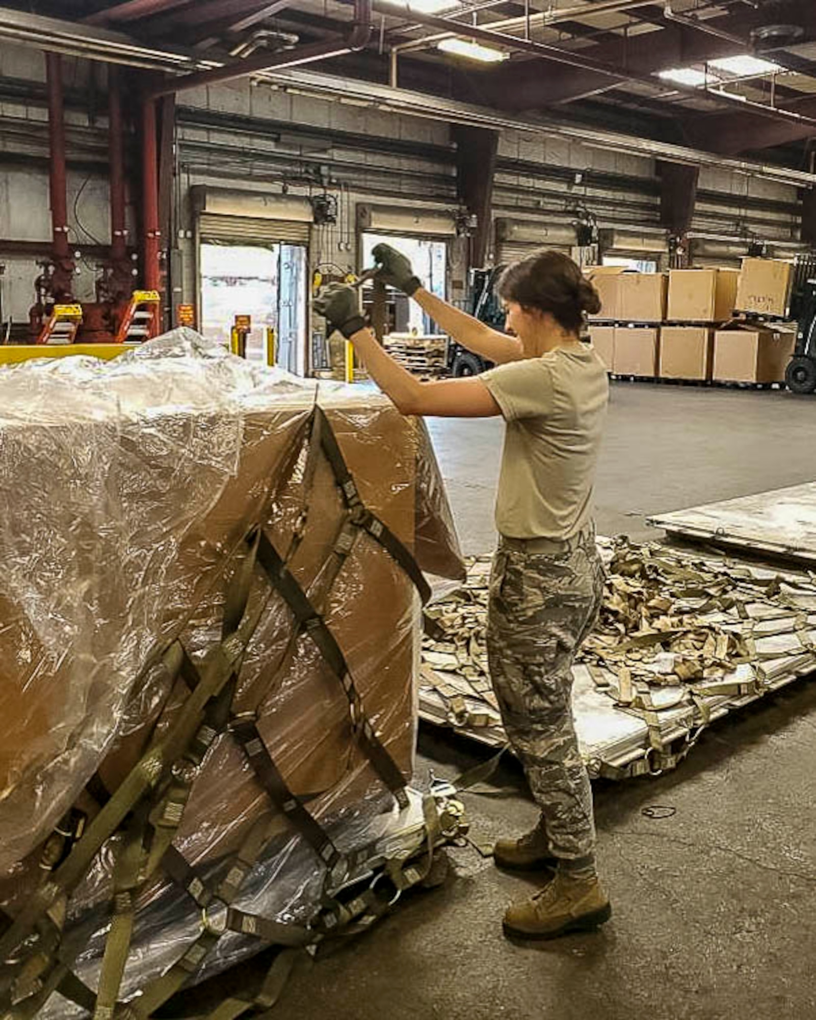 Senior Airman Hannah Gillespie, 96th Aerial Port Squadron air transportation specialist, prepares and palletizes cargo for shipment on June 30, 2018 at Norfolk, Va.  •	The majority of our Reserve members have to meet the same requirements of Active Duty personnel. This means they have to balance a fulltime civilian job or college studies while maintaining their military readiness. Traditional Reservists have one weekend a month, two weeks a year to fulfill training in order to prepare for real world missions and requirements, ensuring strategic depth and readiness. (Courtesy photo)