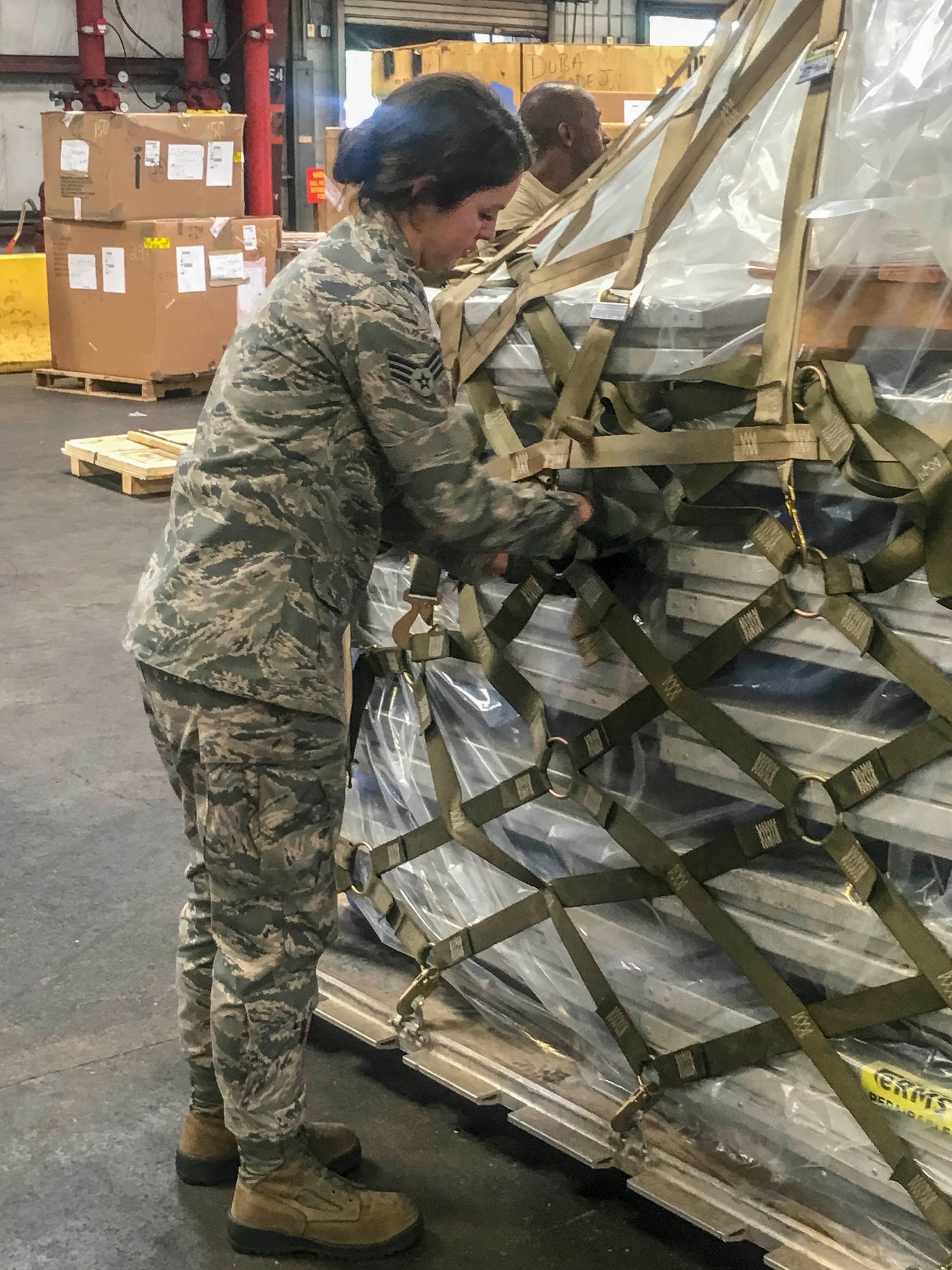 Senior Airman Hannah Gillespie, 96th Aerial Port Squadron air transportation specialist, prepares and palletizes cargo for shipment on June 30, 2018 at Norfolk, Va.  •	The majority of our Reserve members have to meet the same requirements of Active Duty personnel. This means they have to balance a fulltime civilian job or college studies while maintaining their military readiness. Traditional Reservists have one weekend a month, two weeks a year to fulfill training in order to prepare for real world missions and requirements, ensuring strategic depth and readiness. (Courtesy photo)