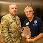 Brig. Gen. Michael J. Glisson, Director, Illinois National Guard Joint Staff, presents Col. (Ret.) Renato “Ron” Bacci, of Wood Dale, Illinois, with the Illinois National Guard Outstanding Service Award for 20 years of volunteer service with the Employers Support of the Guard and Reserve program.