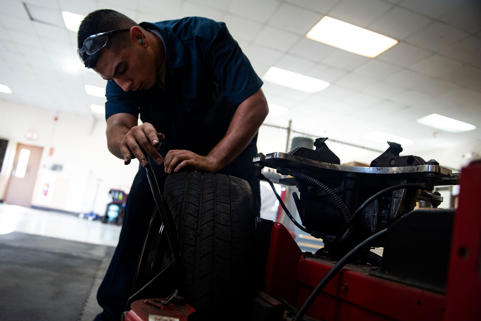 Airman 1st Class Braulio Martinez-Origel, 23d Logistics Readiness Squadron fire truck maintenance apprentice, breaks the bead of a tire inside the customer service section Aug. 20, 2019, at Moody Air Force Base, Ga.  The customer service section serves as the entry point for all vehicles that come in for maintenance, where the Airmen assigned will work on quick fixes that can be done in two hours or less. (U.S. Air Force photo by Senior Airman Erick Requadt)