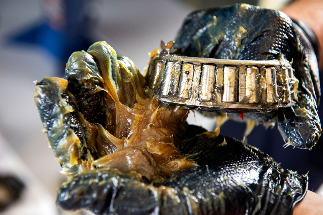 Senior Airman Collin Chatfield, 23d Logistics Readiness Squadron materiel handling equipment maintenance journeyman, re-greases a bearing for a drive axel Aug. 21, 2019, at Moody Air Force Base, Ga. The materiel handling equipment section focuses on the maintenance of cargo-based vehicles such as forklifts and k-loaders. The maintenance of these vehicles enable successful execution of operations, including the loading of cargo onto aircraft for deployments. (U.S. Air Force photo by Senior Airman Erick Requadt)