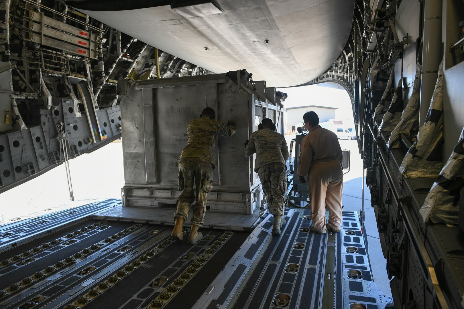 Airmen with the 75th Logistics Readiness Squadron unload cargo from a C-17 Globemaster III at Hill Air Force Base, Utah, Aug. 9, 2019. The C-17 is attached to the Reserve 89th Airlift Squadron assigned to the 445th Aircraft Wing out of Wright-Patterson AFB, Ohio. (U.S. Air Force photo by Cynthia Griggs)