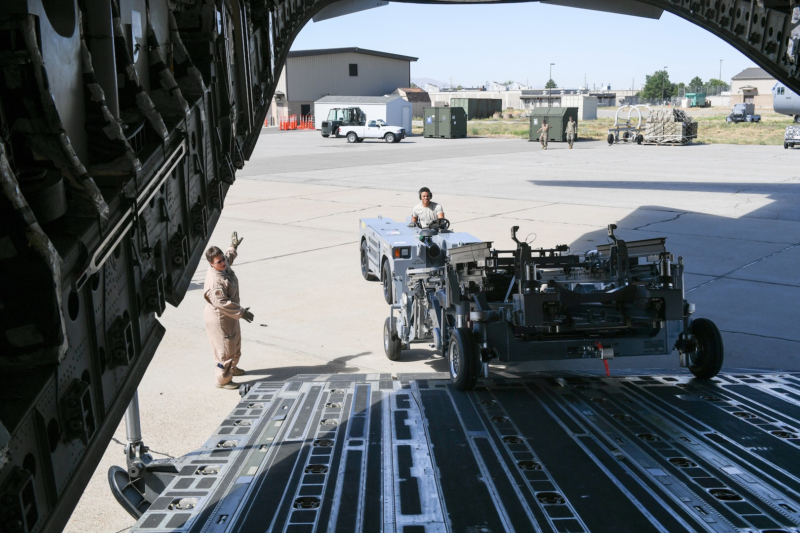 Senior Airman DeShain Calloway, 75th Logistics Readiness Squadron, unloads cargo from a C-17 Globemaster III at Hill Air Force Base, Utah, Aug. 9, 2019, with guidance from loadmaster Senior Master Sgt. Denise Roberts, 89th Airlift Squadron. The Reserve 89th AS is assigned to the 445th Aircraft Wing out of Wright-Patterson AFB, Ohio. (U.S. Air Force photo by Cynthia Griggs)