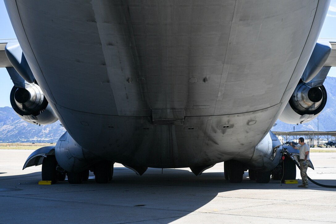 Crew Chief Tech. Sgt. Ronnie Calloway, 75th Logistics Readiness Squadron, fuels up a  C-17 Globemaster III at Hill Air Force Base, Utah, Aug. 9, 2019. The C-17 is attached to the Reserve 89th Airlift Squadron assigned to the 445th Aircraft Wing out of Wright-Patterson AFB, Ohio. (U.S. Air Force photo by Cynthia Griggs)