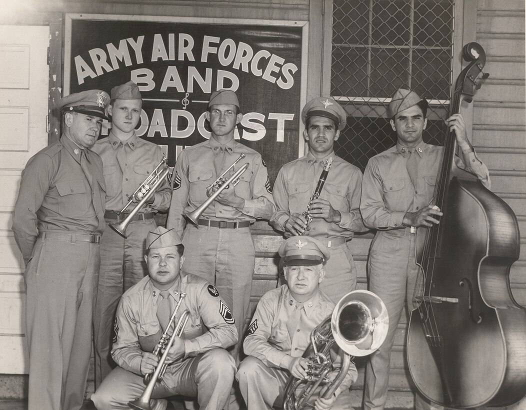 Members of the Army Air Corps Band pose for a photo after being broadcast to military members around the world. When the band recorded, the sound was captured on large recording lathes and a master vinyl disc was cut directly from the transmission.