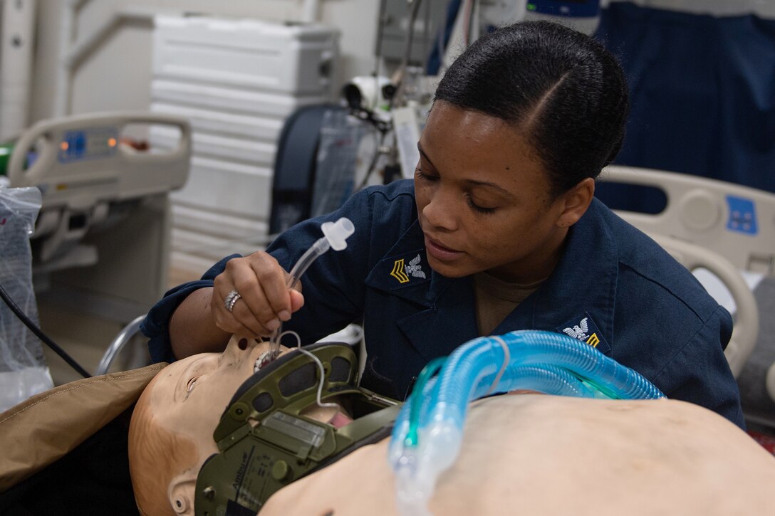 A sailor practices giving medical care.