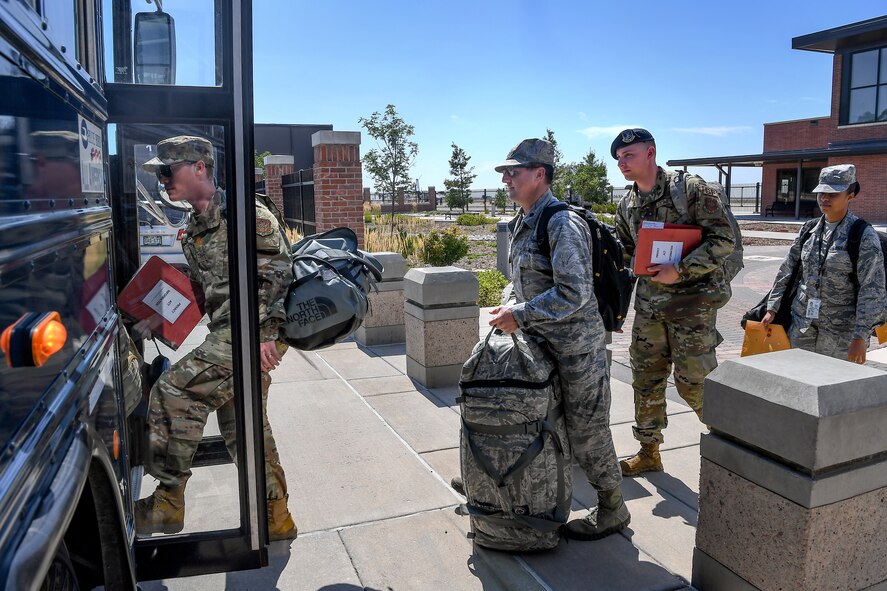 PETERSON AIR FORCE BASE, Colo. - Airmen board a bus with deployment gear during Front Range Expeditionary Exercise 19-02 at Peterson Air Force Base, Colorado, Aug. 20, 2019. During the exercise Schriever Airmen experienced real-time pre-deployment procedures to test the mobilization effectiveness of the 50th Space Wing. (U.S. Air Force photo by Kathryn Calvert)