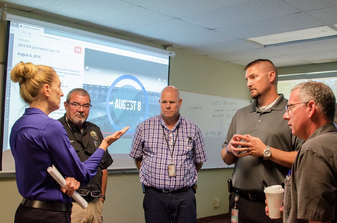 Shelley Dragomir, dam safety program manager (left), and Jeff Daniels, chief, Readiness and Contingency Operations (right), both from USACE-Albuquerque District, discuss future coordination efforts with stakeholders during the exercise at Lamar Community College August 15, 2019. Stakeholders (l-r): Rex Beemer, emergency manager, Kansas; Ralph Goodnight, emergency manager, Kansas and Jerrad Webb, emergency manager, Kansas.