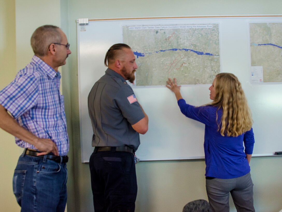 Mark Yuska, chief, Operations (left), and Amy Louise, Arkansas River Basin manager, both USACE-Albuquerque District, discuss inundation with Jeremy Burkhart, chief and emergency manager, Lamar Fire Department, during the exercise at Lamar Community College August 15, 2019.