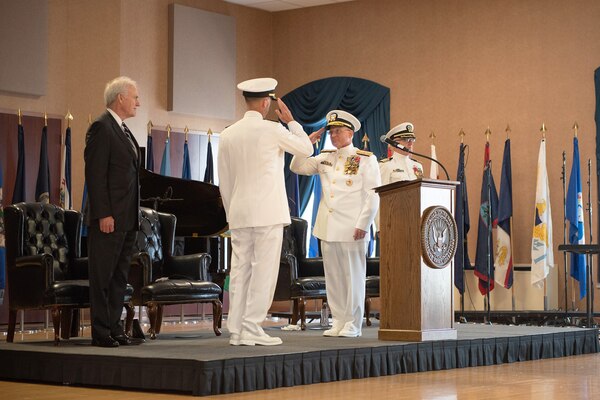 Outgoing and incoming chiefs of naval operations salute.