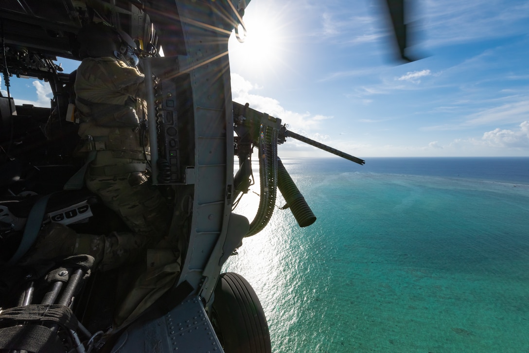 U.S. Air Force Staff Sgt. Jose Diaz de Leon, special mission aviator assigned to the 33rd Rescue Squadron, fires a GAU-18 machine gun aboard an HH-60G Pave Hawk, July 31, 2019, out of Kadena Air Base, Japan. The HH-60G Pave Hawk’s primary function is to recover personnel in hostile conditions day and night, no matter the weather. (U.S. Air Force photo by Senior Airman Cynthia Belío)