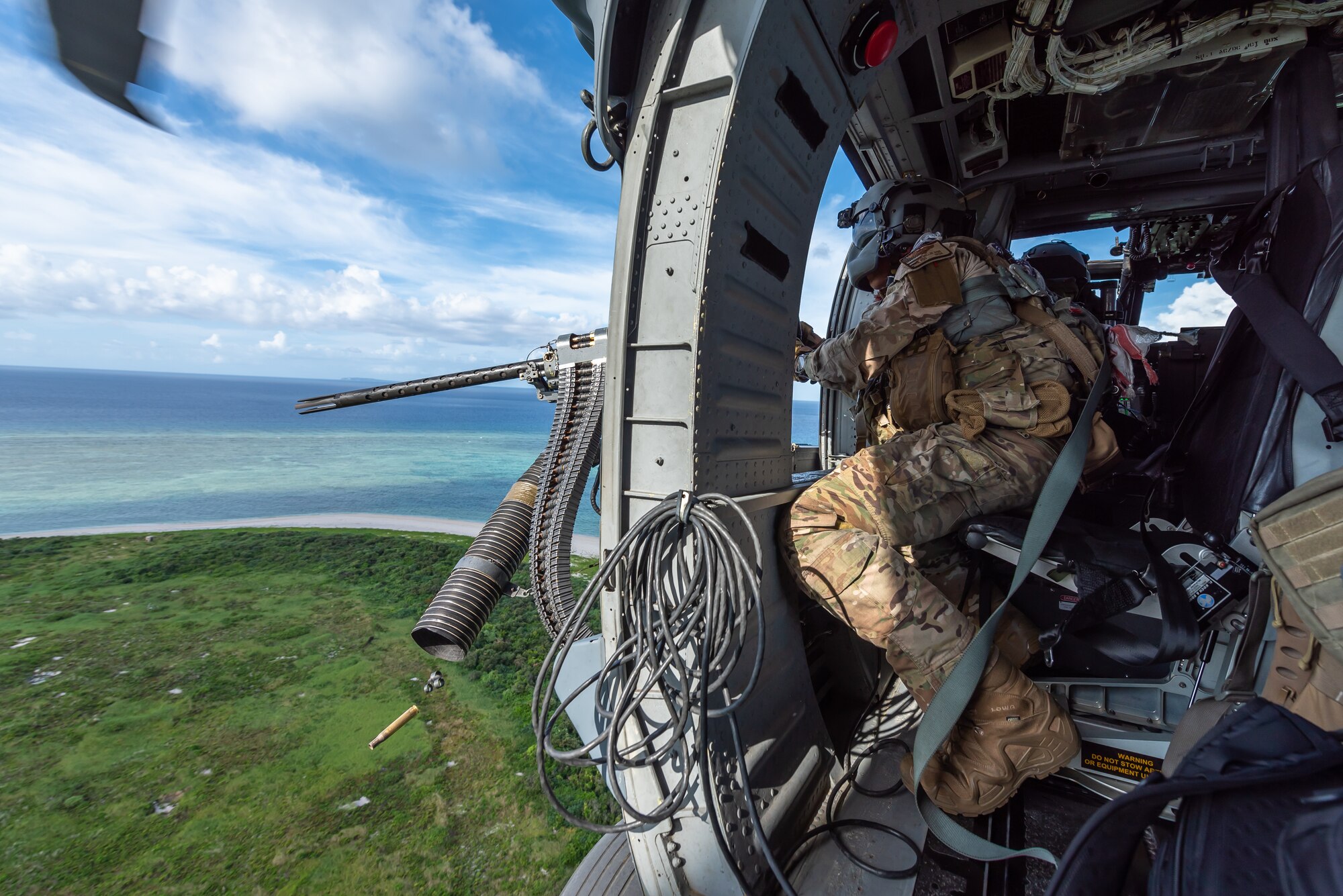 U.S. Air Force Tech. Sgt. Keon Miller, special mission aviator assigned to the 33rd Rescue Squadron, fires a GAU-18 machine gun aboard an HH-60G Pave Hawk, July 31, 2019, out of Kadena Air Base, Japan. The HH-60G Pave Hawk’s core mission is recovery of personnel under hostile conditions, including combat search and rescue. (U.S. Air Force photo by Airman 1st Class Matthew Seefeldt)