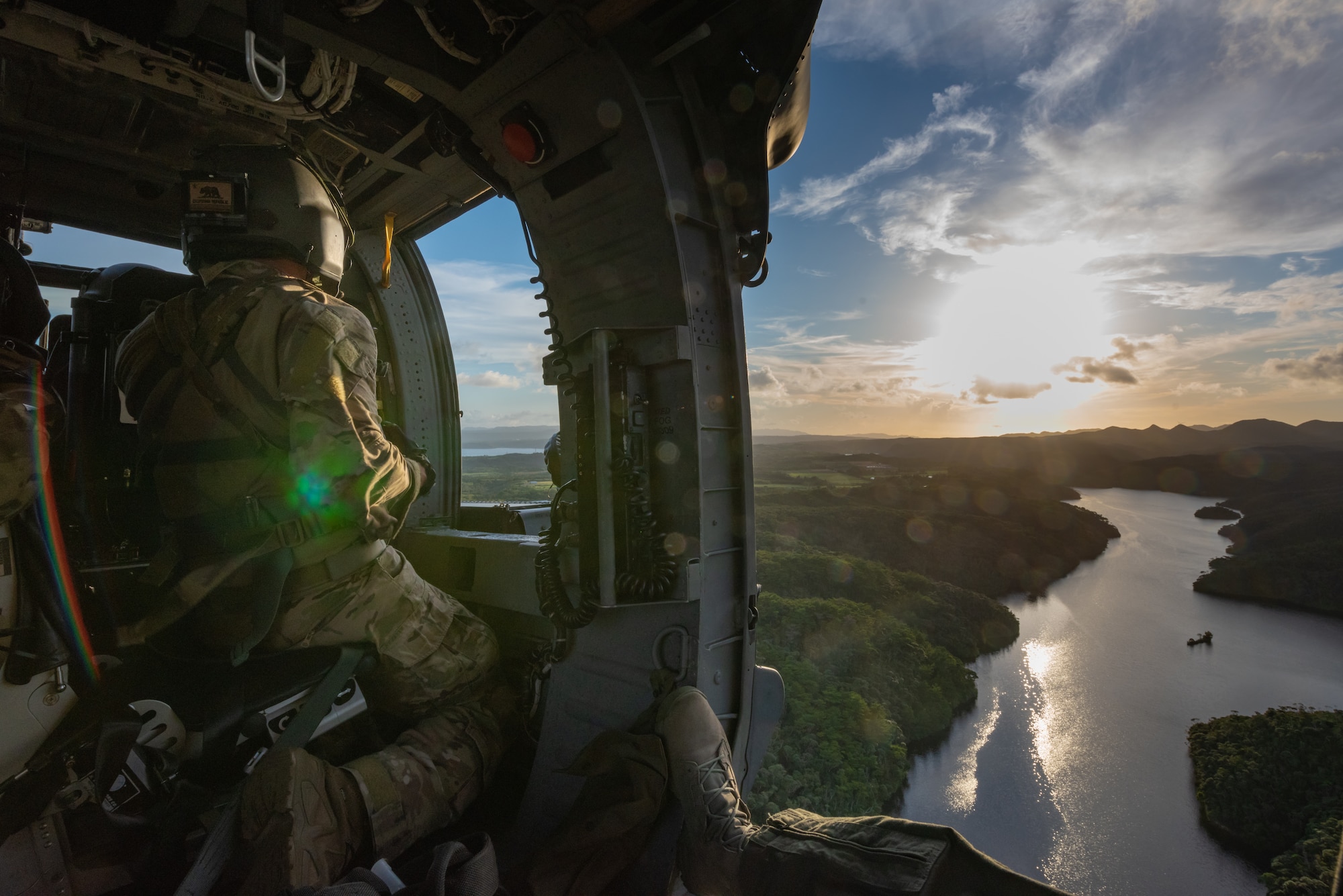 U.S. Air Force Staff Sgt. Jose Diaz de Leon, special mission aviator assigned to the 33rd Rescue Squadron, looks out the gunner’s window aboard an HH-60G Pave Hawk, July 31, 2019, out of Kadena Air Base, Japan. The HH-60G Pave Hawk, or Precision Avionics Vectoring Equipment, has a hoist that can lift up to 600 pounds during personnel recovery operations. (U.S. Air Force photo by Senior Airman Cynthia Belío)