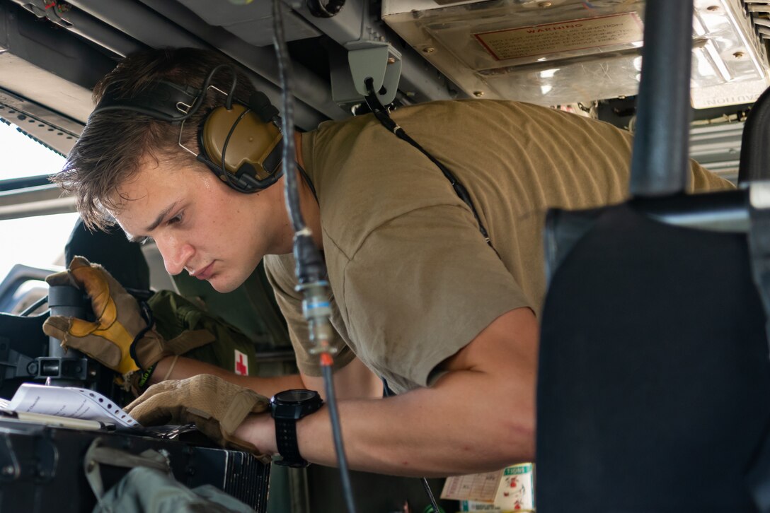 U.S. Air Force Airman 1st Class Jack Peterson, special mission aviator assigned to the 33rd Rescue Squadron, performs pre-flight checks aboard an HH-60G Pave Hawk, July 31, 2019, on Kadena Air Base, Japan. The HH-60G Pave Hawk, or Precision Avionics Vectoring Equipment, has a hoist that can lift up to 600 pounds during personnel recovery operations. (U.S. Air Force photo by Senior Airman Cynthia Belío)
