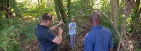 Training Support Center (TSC) Benelux employees, a contractor assigned to the Directorate of Public Works, U.S. Army Garrison Benelux, and a member of Integrated Training Area Management, assess a dried-out waterway in the Alliance Training Area on Chièvres Air Base, Belgium, July 23, 2019