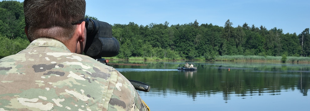 A U.S. Soldier with 173rd Airborne Brigade reviews the shooting results of a Polish sniper team during the water shoot event of the European Best Sniper Team Competition at Grafenwoehr, Germany, July 24, 2019.
