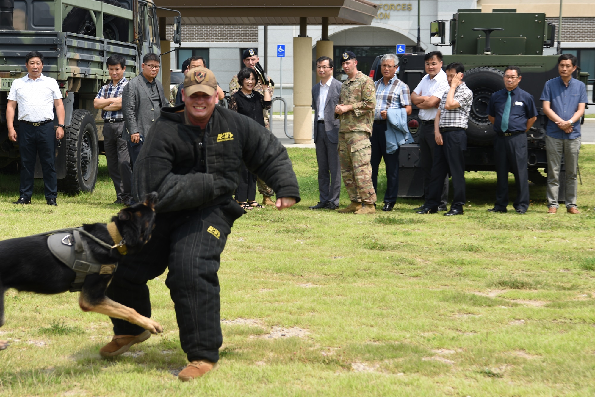 The 8th Security Forces Squadron provide a military working dog demonstration for the Korean National Police Gunsan City branch members at Kunsan Air Base, Republic of Korea, Aug. 20, 2019. The KNP visited the 8th SFS for a tour to learn about the different defensive measures of the base. (U.S. Air Force photo by Staff Sgt. Joshua Edwards)
