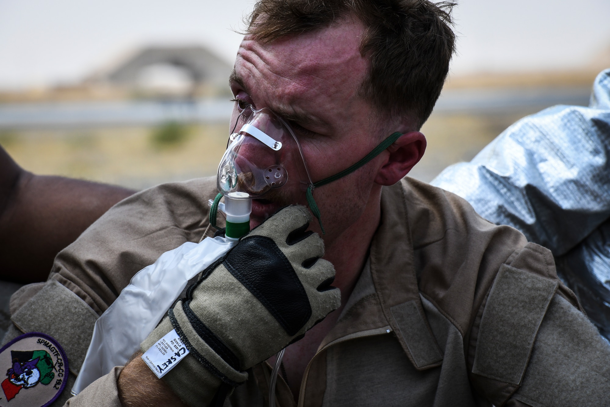 U.S. military service members participate in an airfield exercise at Ahmed al-Jaber Air Base, Kuwait, Aug. 16, 2019. Several emergency service vehicles arrived on-scene and simulated putting out the fire in the MV-22 Osprey then providing immediate medical care to the victims. Firefighters and medical personnel included Airmen, Marines and Sailors. (U.S. Air Force photo by Senior Airman Lane T. Plummer)