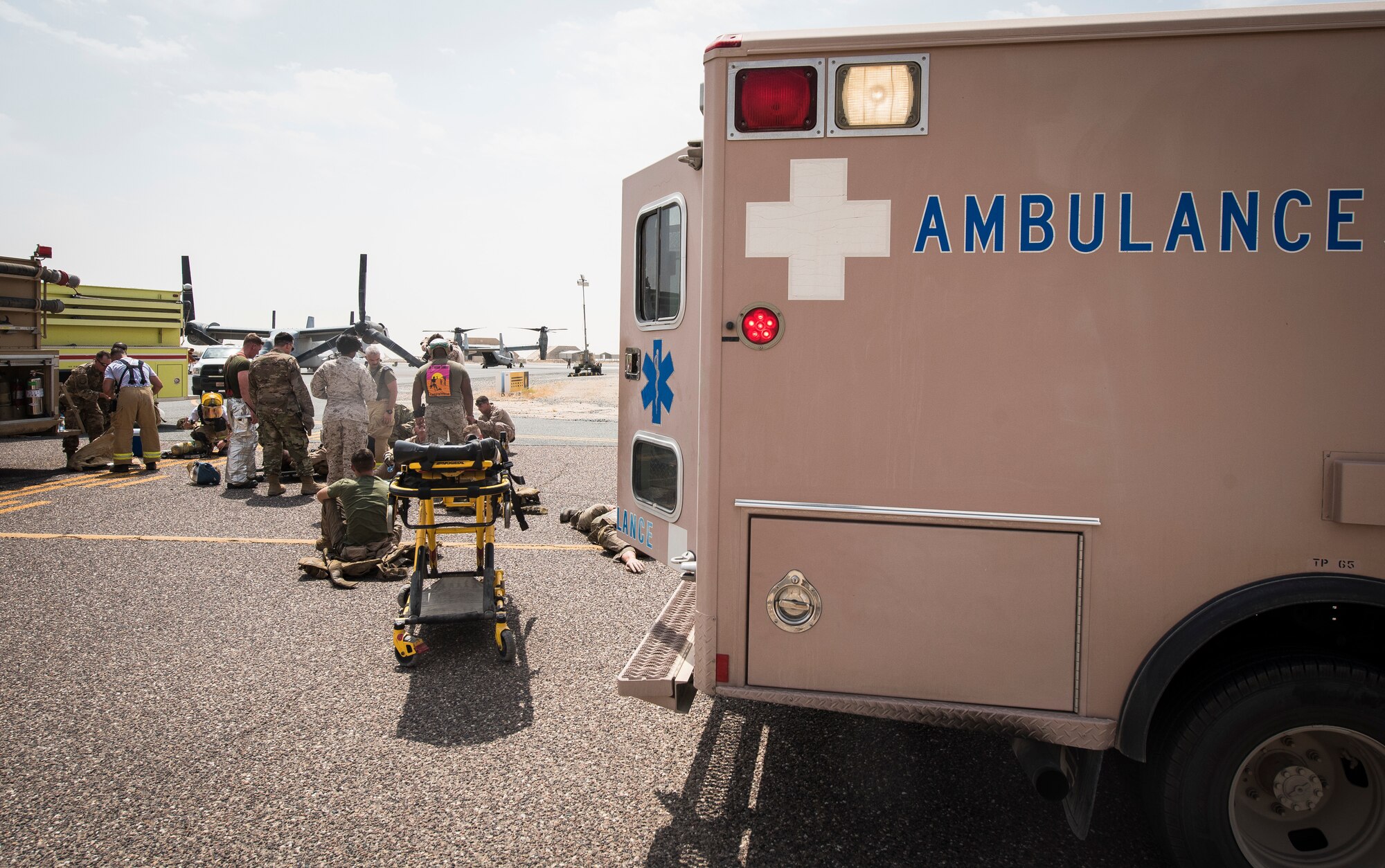 U.S. military service members participate in an airfield exercise at Ahmed al-Jaber Air Base, Kuwait, Aug. 16, 2019. The exercise was an opportunity for service members from multiple branches to cooperate on one of the most intense scenarios a firefighter could be called for: an aircraft on fire on the flightline. (U.S. Air Force photo by Senior Airman Lane T. Plummer)