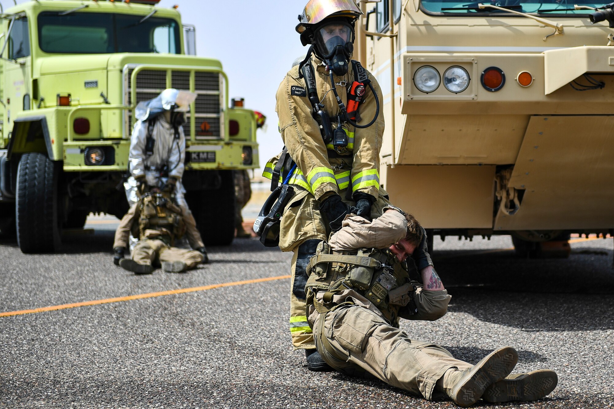 A firefighter with the 407th Expeditionary Civil Engineer Squadron removes a simulated casualty from an MV-22 Osprey during an airfield exercise at Ahmed al-Jaber Air Base, Kuwait, Aug. 16, 2019. The exercise was an opportunity for service members from multiple branches to cooperate on one of the most intense scenarios a firefighter could be called for: an aircraft on fire on the flightline. (U.S. Air Force photo by Staff Sgt. Mozer O. Da Cunha)