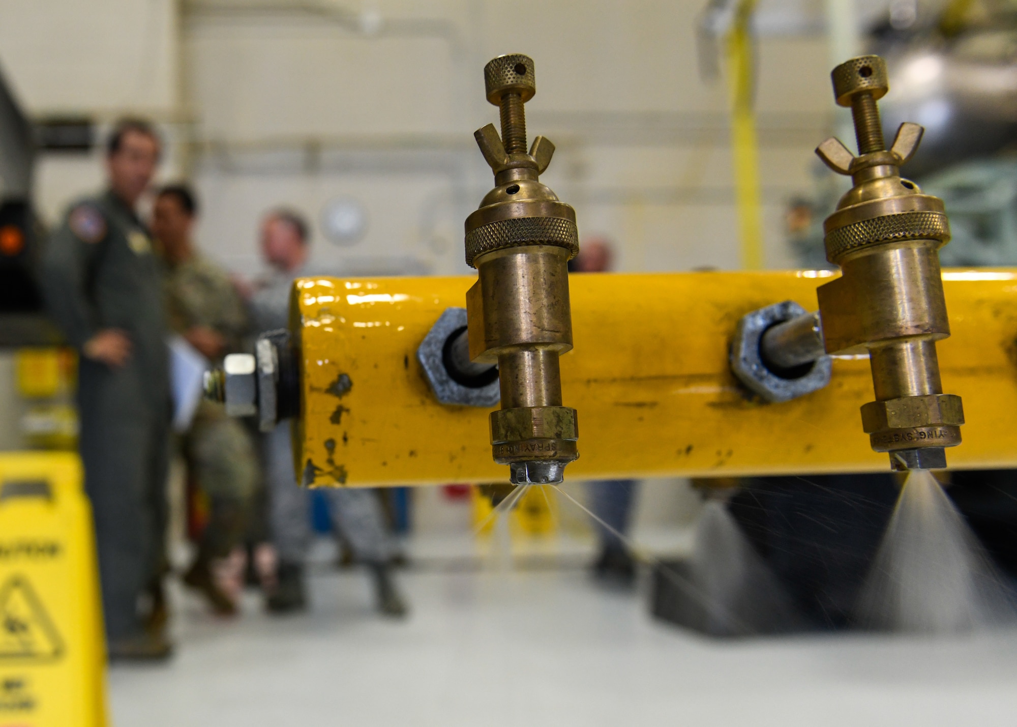 A nozzle of the Modular Aerial Spray System (MASS) releases water from its tank as a demonstration for Peruvian Air Force Major General Carlos G. Elera Camacho, the Assistant Defense and Air Attaché to the Embassy of Peru in the United States of America, June 17, 2019, here.