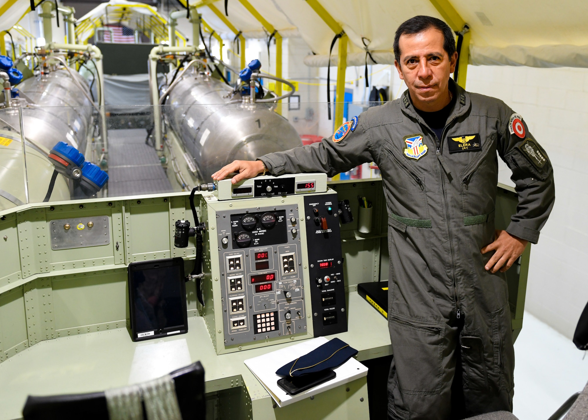 Peruvian Air Force Major Gen. Carlos G. Elera Camacho, the Assistant Defense and Air Attaché to the Embassy of Peru in the United States of America, poses for a photo with a Modular Aerial Spray System (MASS), June 17, 2019, here.