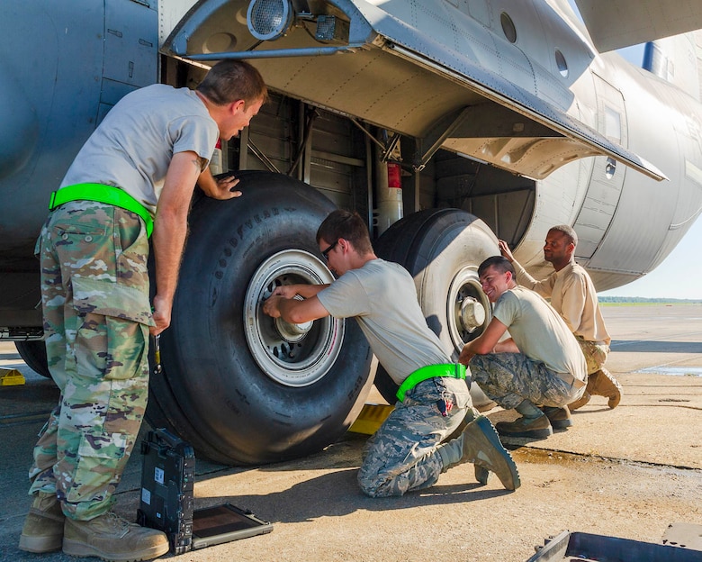 Air Force Reserve Airmen from the 913th Maintenance Squadron work with 19th Airlift Wing active duty members to troubleshoot the landing gear of a C-130J Hercules on August 15, 2019, at Little Rock Air Force Base, Ark.  There are 20 Reserve members who work with Team Little Rock maintenance personnel to ensure combat airlift is available. Mobility aircraft, such as the C-130J, deliver critical personnel and cargo and provide airdrop of time-sensitive supplies, food and ammunition on a global scale. A critical part of the airlift capabilities are the efforts of the maintenance personnel who ensure the workhorse of the mobility force, the C-130, is always ready, always there! (U.S. Air Force Reserve photo by Maj. Ashley Walker)