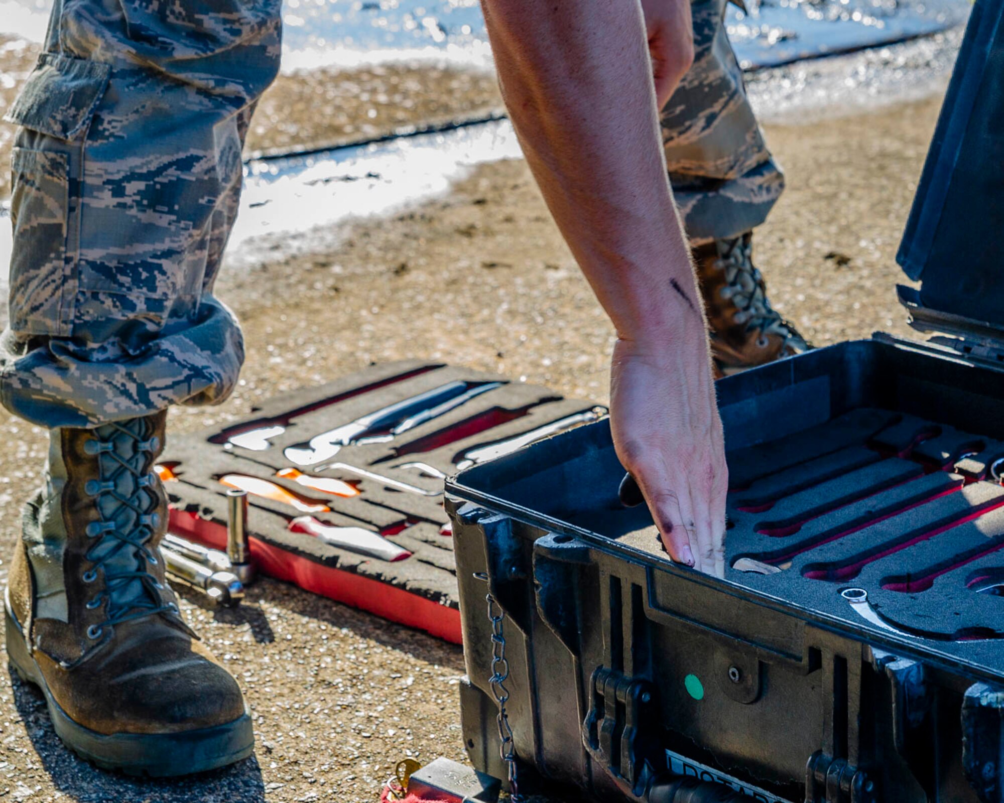 Air Force Reserve Airman from the 913th Maintenance Squadron looks for a tool to troubleshoot the landing gear of a C-130J Hercules on August 15, 2019, at Little Rock Air Force Base, Ark.  There are 20 Reserve members who work with Team Little Rock maintenance personnel to ensure combat airlift is available. Mobility aircraft, such as the C-130J, deliver critical personnel and cargo and provide airdrop of time-sensitive supplies, food and ammunition on a global scale. A critical part of the airlift capabilities are the efforts of the maintenance personnel who ensure the workhorse of the mobility force, the C-130, is always ready, always there! (U.S. Air Force Reserve photo by Maj. Ashley Walker)