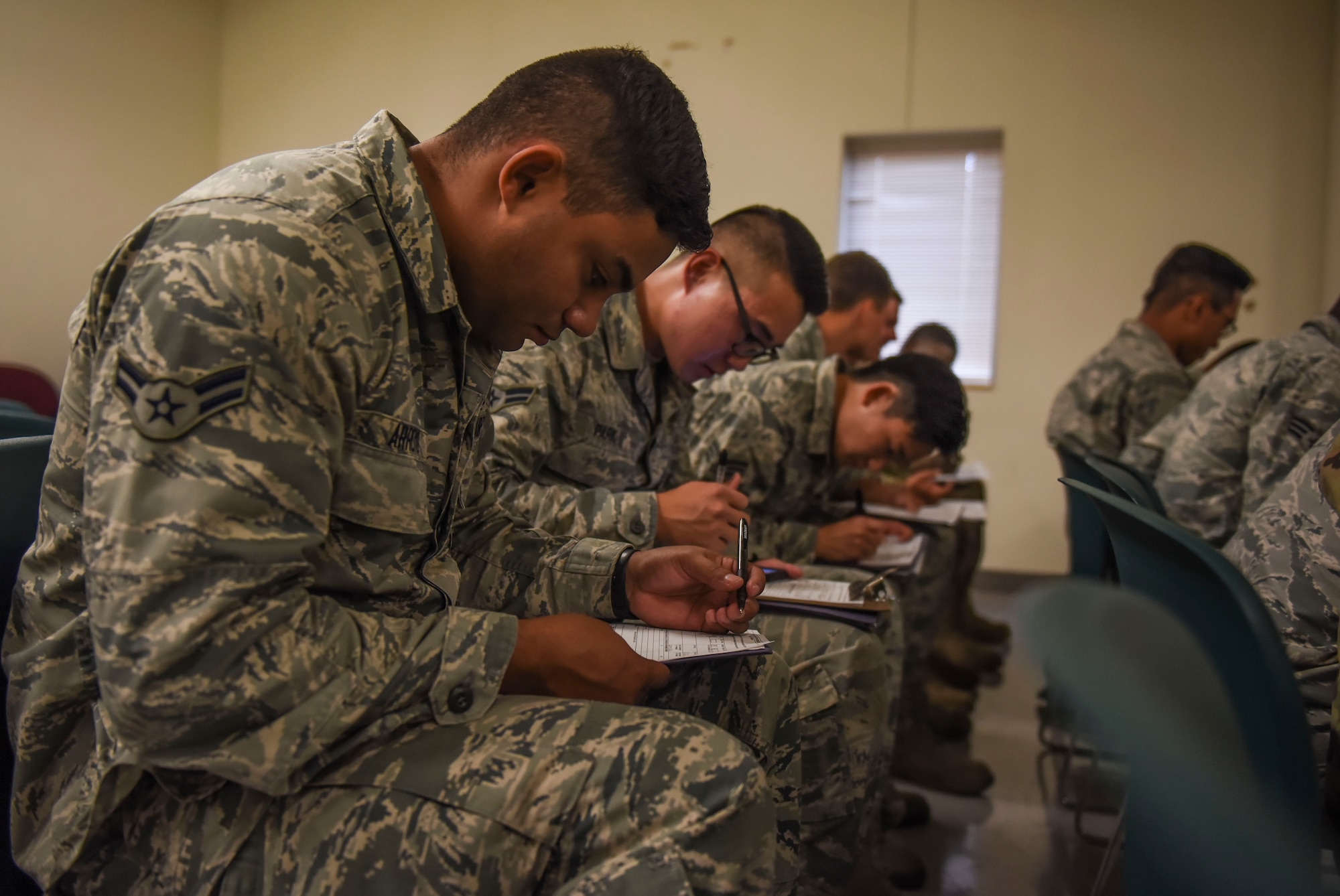 U.S. Air Force Airman 1st Class Mark Arroyo, 436th Civil Engineer Squadron water and fuels system maintainer, Dover Air Force Base, Delaware, fills out in-processing forms to participate in Exercise Mobility Guardian 2019 at Fairchild Air Force Base, Washington, Aug 16, 2019.