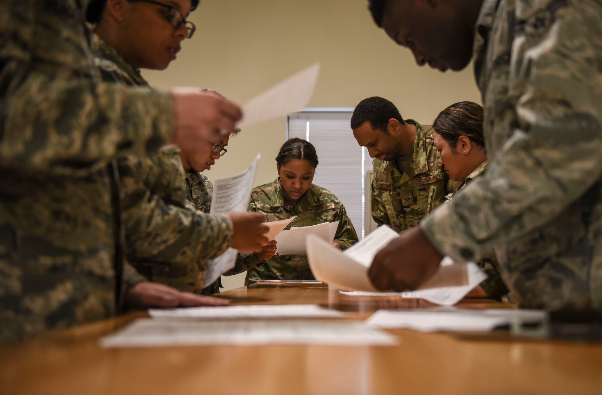 Members of Team Fairchild check paperwork for incoming personnel participating in Exercise Mobility Guardian 2019 at Fairchild Air Force Base, Washington, Aug 16, 2019.