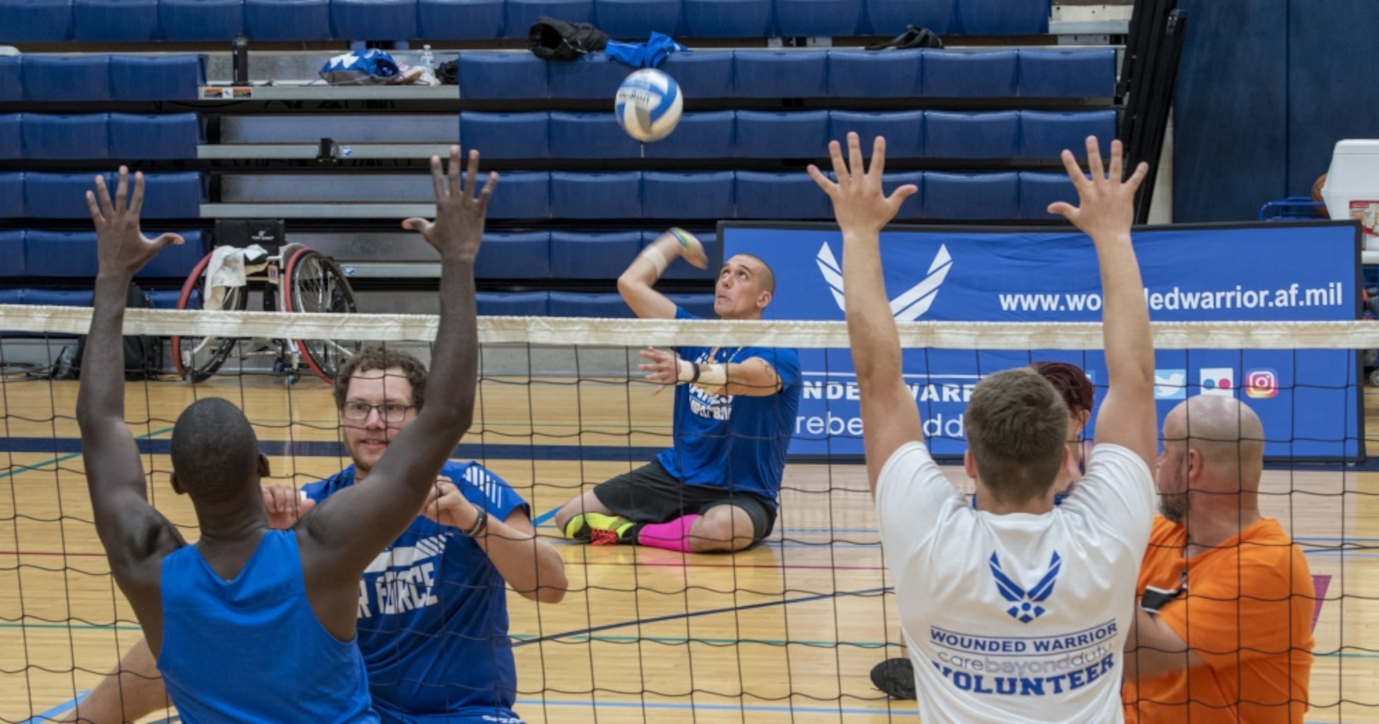 Wounded warrior serves volleyball.