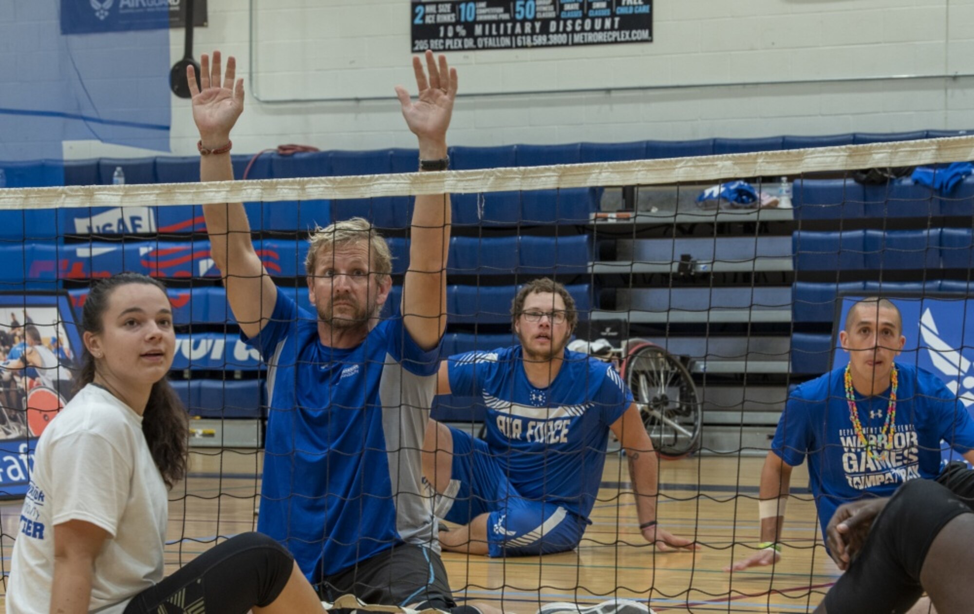 Wounded warriors play volleyball.