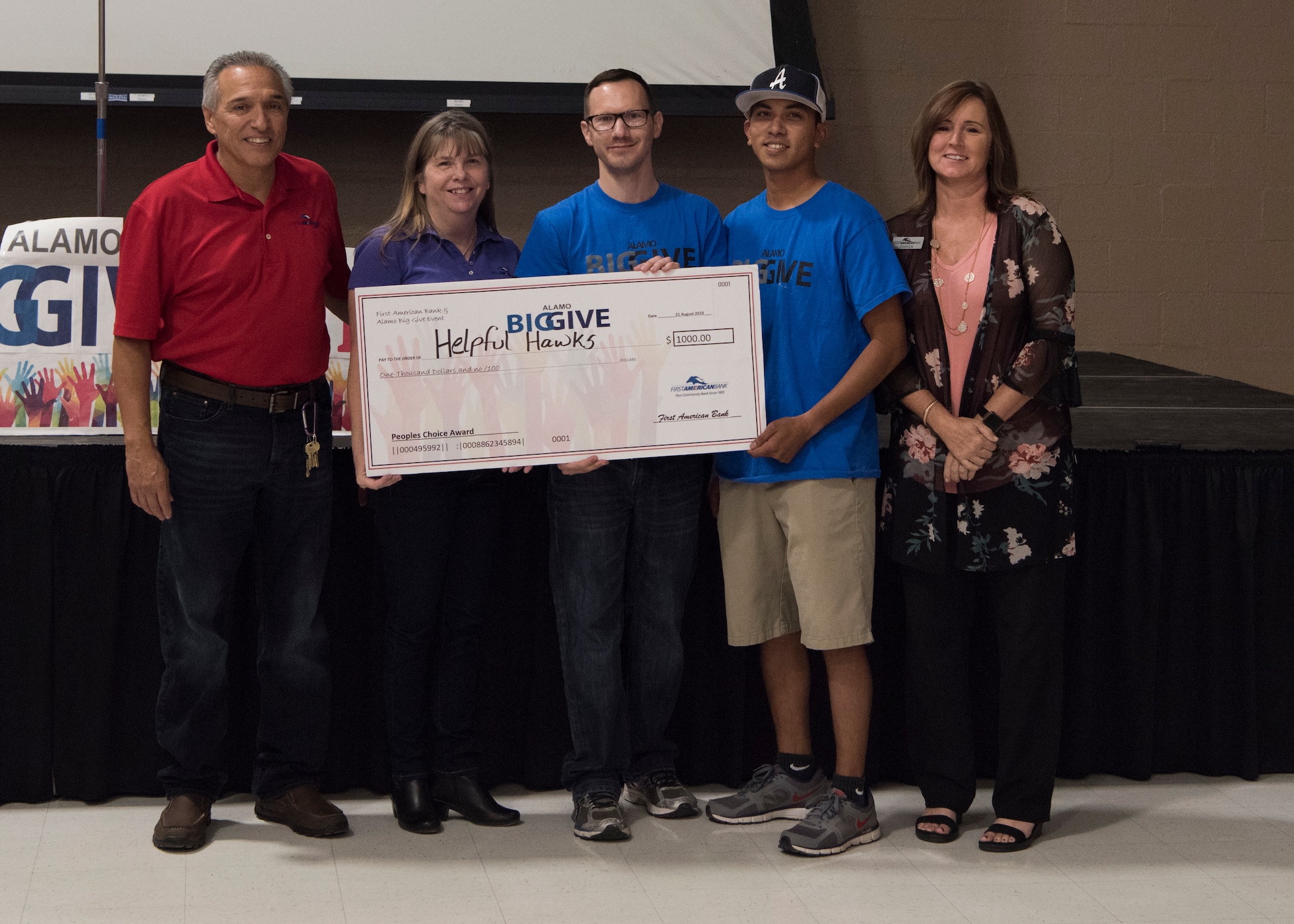 Members of team Helpful Hawks accept a check for winning the people’s choice category as part of the 2019 Alamo’s Big Give closing ceremony, August 22, at the Willie Estrada Civic Center in Alamogordo, N.M. This was the 12th year of Alamo’s Big Give which has saved the Otero community over $2,000,000 through community service. (U.S. Air Force photo by Staff Sgt. BreeAnn Sachs)