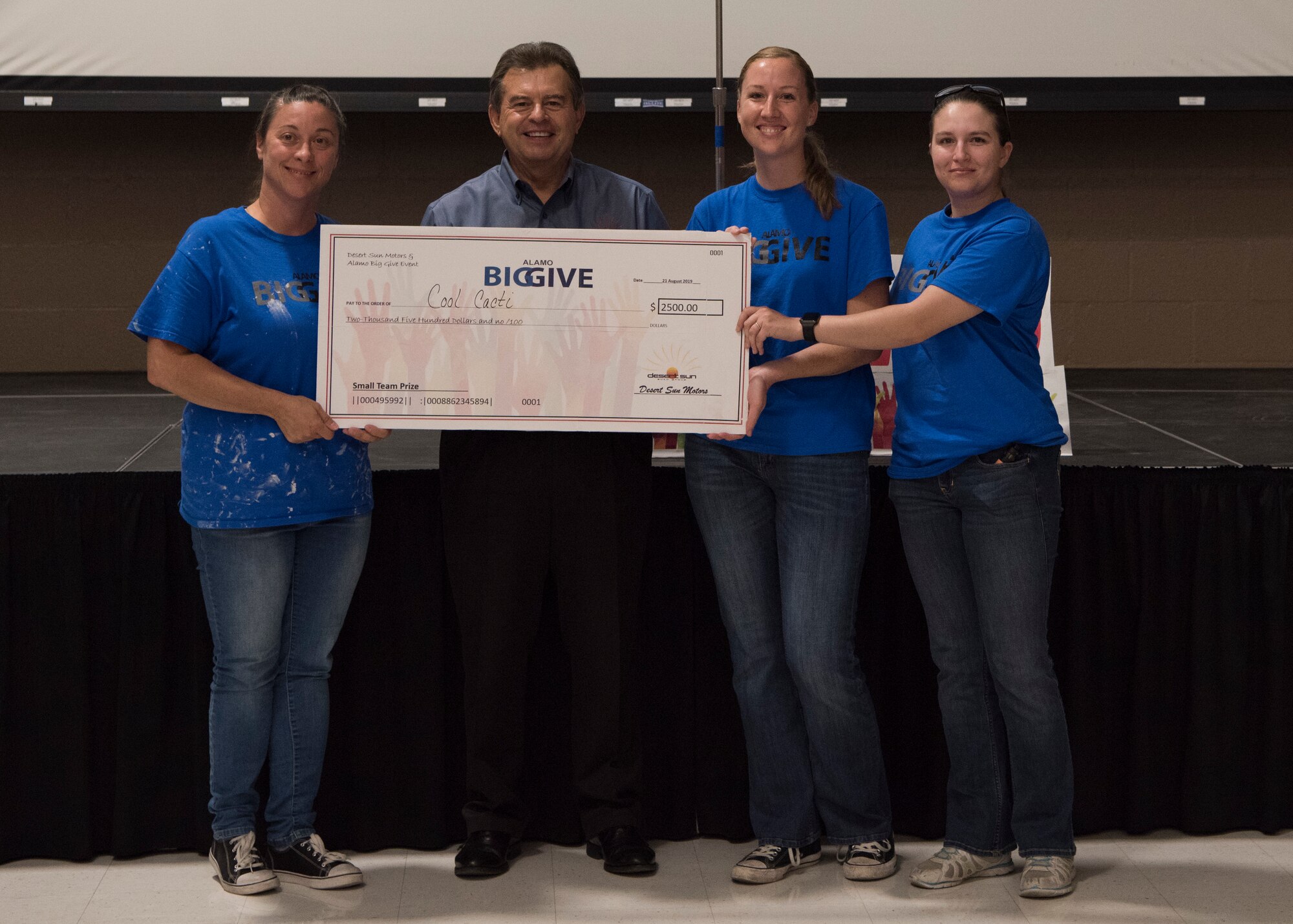 Members of team Cool Cacti accept a check for winning in the small team category as part of the 2019 Alamo’s Big Give closing ceremony, August 22, at the Willie Estrada Civic Center in Alamogordo, N.M. This was the 12th year of Alamo’s Big Give which has saved the Otero community over $2,000,000 through community service. (U.S. Air Force photo by Staff Sgt. BreeAnn Sachs)