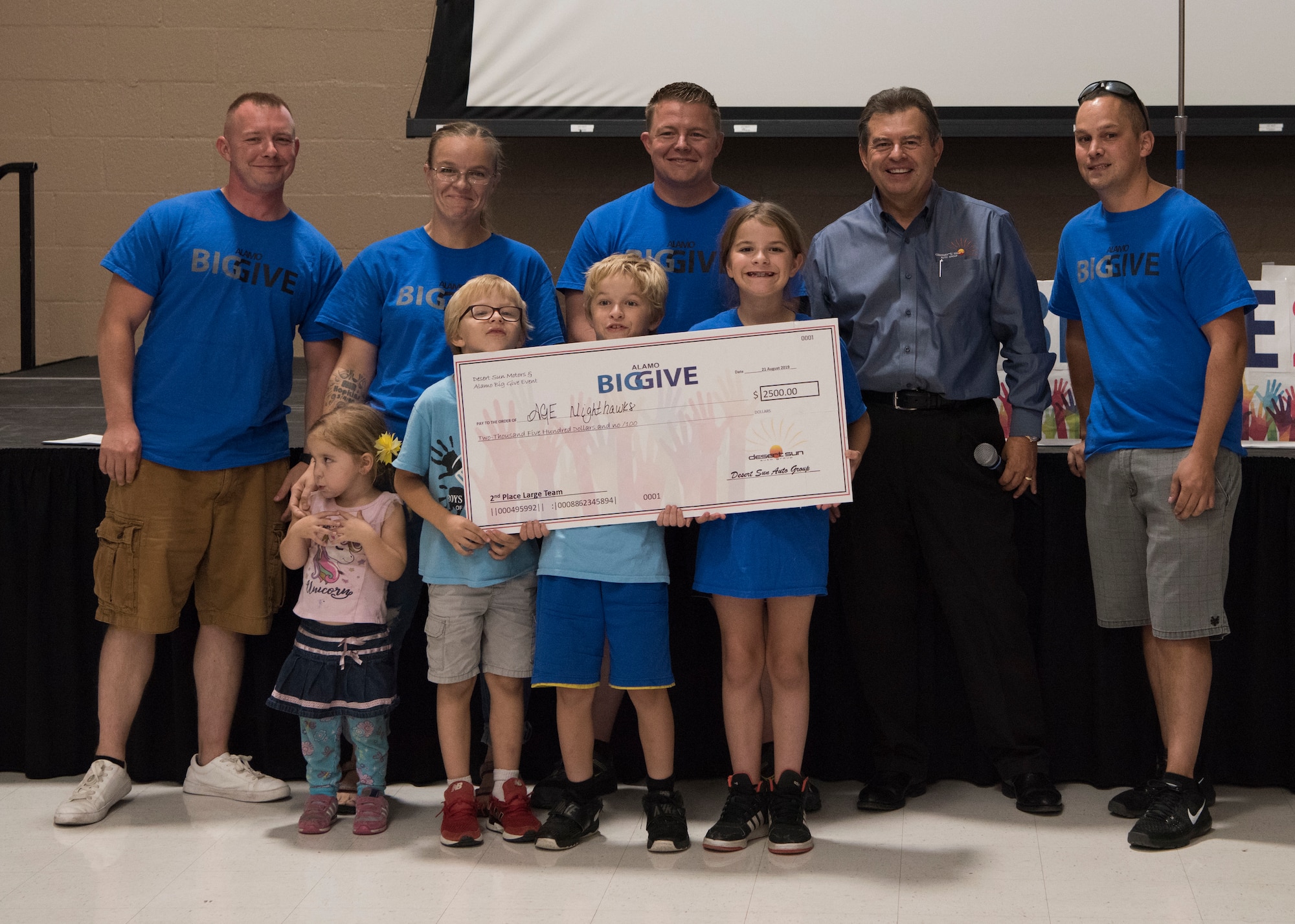 Members of team ACE Knight Hawks accept a check for winning 2nd place in the large team category as part of the 2019 Alamo’s Big Give closing ceremony, August 22, at the Willie Estrada Civic Center in Alamogordo, N.M. This was the 12th year of Alamo’s Big Give which has saved the Otero community over $2,000,000 through community service. (U.S. Air Force photo by Staff Sgt. BreeAnn Sachs)