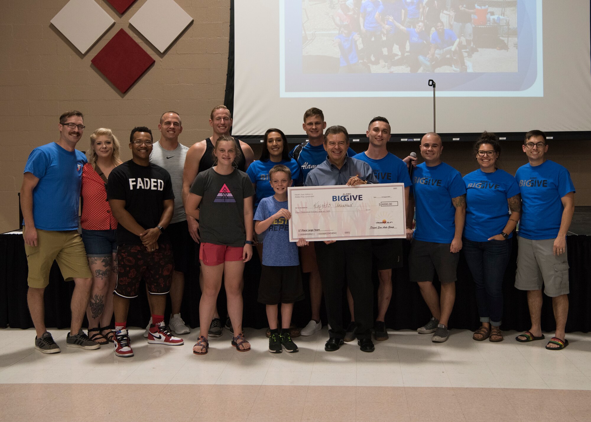 Members of team Knights Unleashed accept a check for winning 1st place in the large team category as part of the 2019 Alamo’s Big Give closing ceremony, August 22, at the Willie Estrada Civic Center in Alamogordo, N.M. This was the 12th year of Alamo’s Big Give which has saved the Otero community over $2,000,000 through community service. (U.S. Air Force photo by Staff Sgt. BreeAnn Sachs)