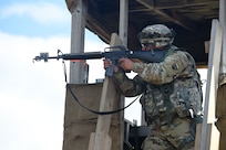 Spc. Dimitri Persad, Motor Transportation Operations Specialist, 211th Inland Cargo Transfer Company, Garden Grove, California, fires at the enemy from a guard tower during a day time attack on August 18, 2019.