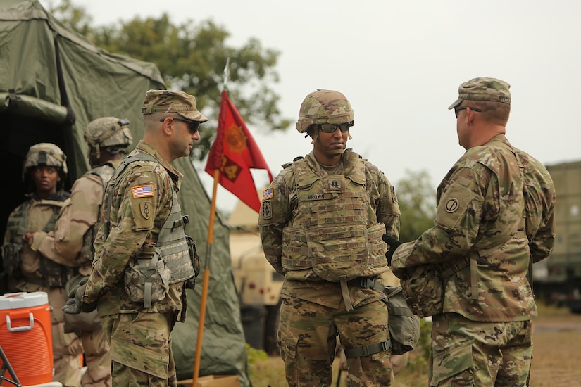 Army Reserve Col. Daniel Jaquint, left, 85th U.S. Army Reserve Support Command, with Command Sgt. Maj. Ryan Welch, right, 1-340th Training Support Battalion, 85th U.S. Army Reserve Support Command, discuss training with Capt. Alicia Brown, Company Commander, 414th Transportation Company and how she feels her company’s tactical operations are progresing,  August 20, 2019.