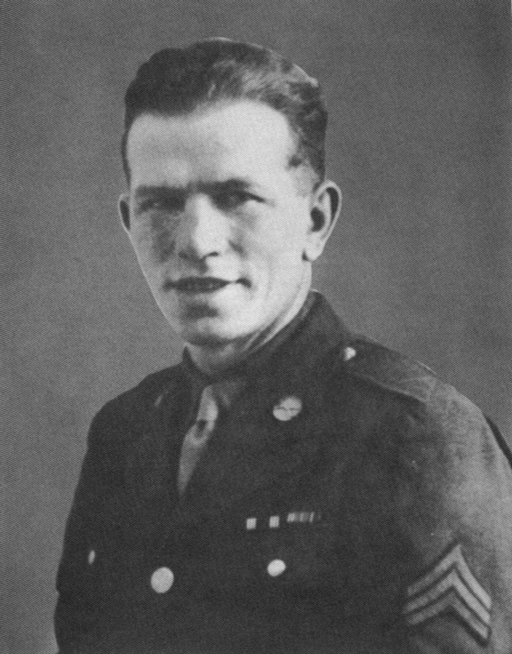 A soldier in dress uniform looks at the camera.