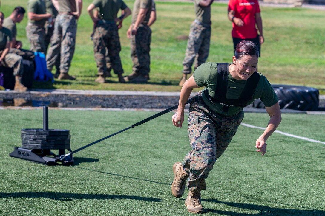 A Marine pulls a weighted sled.