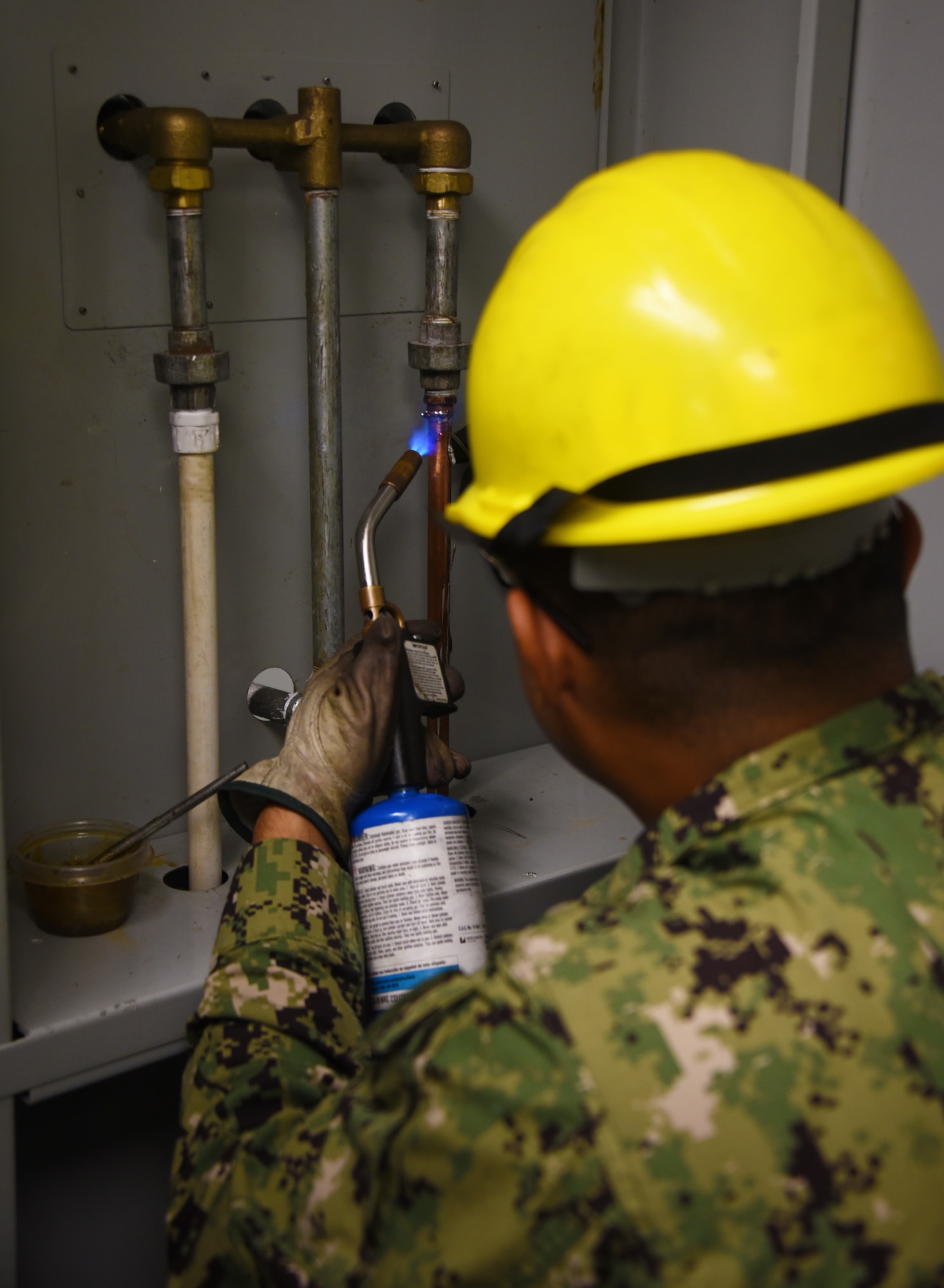 366th Training Squadron water and fuels systems maintenance course student, uses a blowtorch on copper tubing to create a hot water distribution system at Sheppard Air Force Base