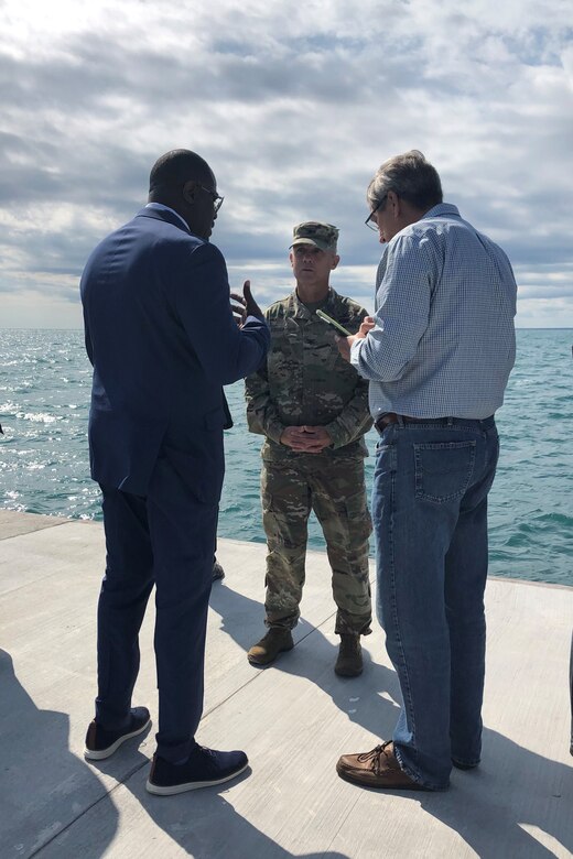 Mayor of Waukegan, Illinois, Sam Cunningham (left), speaks with Col. Aaron Reisinger (center), commander and district engineer of the U.S. Army Corps of Engineers Chicago District, following a ribbon cutting ceremony for the Waukegan South Pier Aug. 22. The Corps removed deteriorated concrete, placed new concrete and added nine new access ladders. (U.S. Army photo by Christina Eddleman/Released)