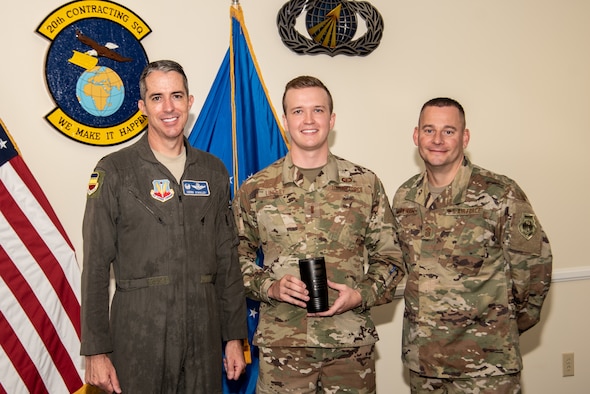 U.S. Air Force Col. Derek O'Malley, 20th Fighter Wing commander, left, 2nd Lt. Jordan Lindley, 20th Contracting Squadron contract specialist, center, and Chief Master Sgt. Jason Morehouse, 20th Fighter Wing command chief, stand for a photo as Lindley is recognized as Weasel of the Week (WOW) at Shaw Air Force Base (AFB), South Carolina, Aug. 8, 2019.