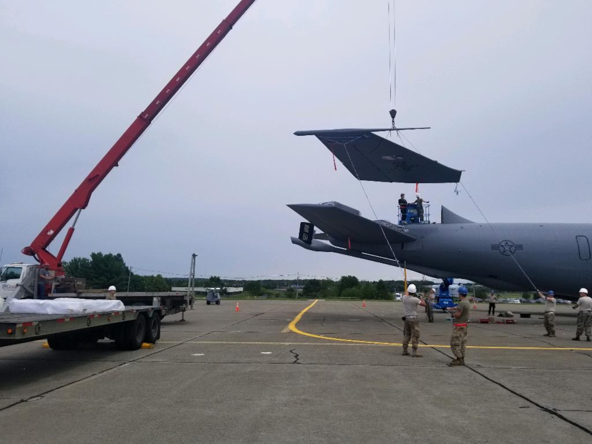 U.S. Air Force Airmen remove the tail of a KC-135 Stratotanker at Bangor Air National Guard Base, Maine, July 2019.