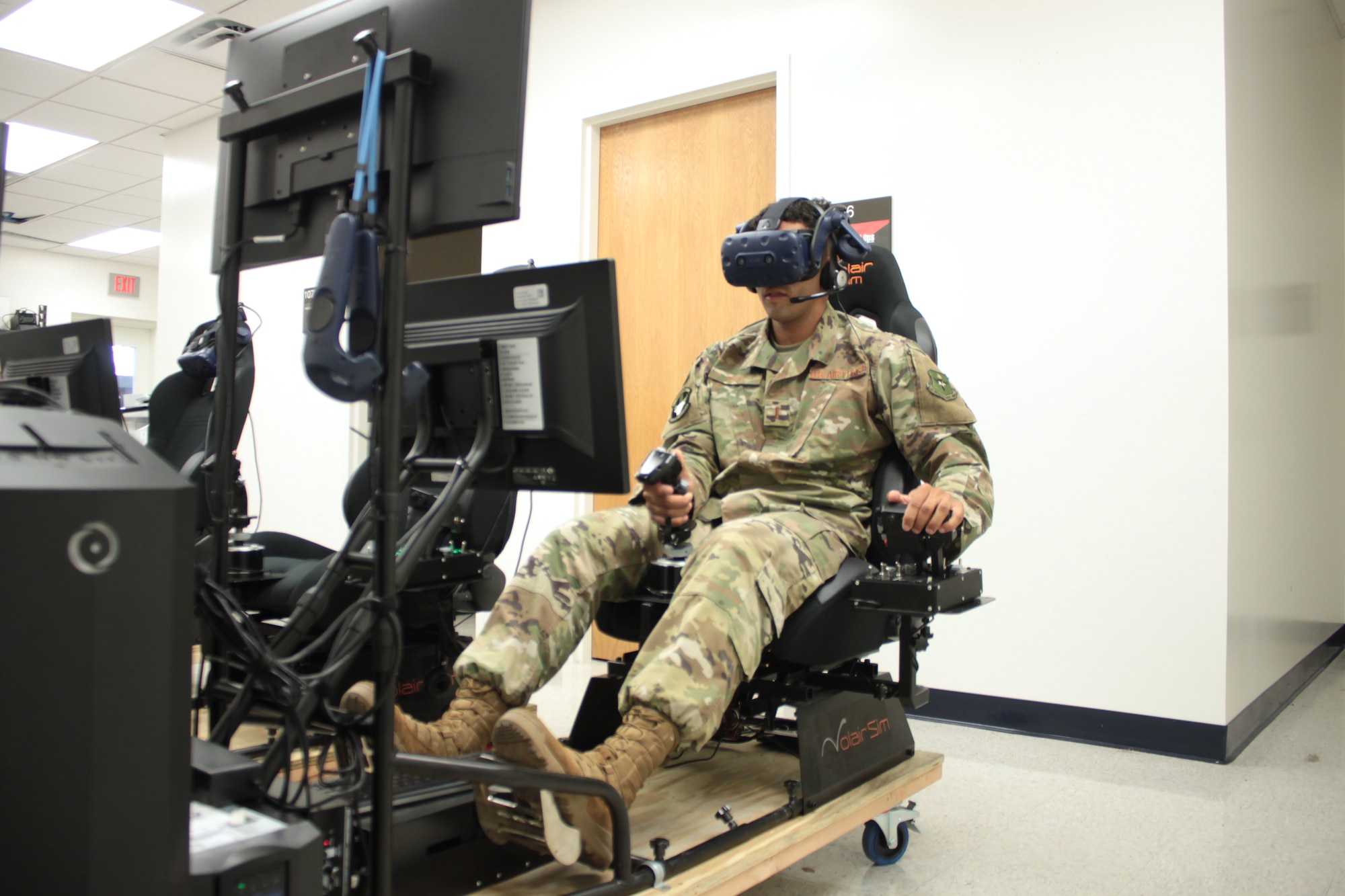 U.S. Air Force 2nd Lt. Isaac Perez flies a training sortie on a virtual reality simulator at Air Education and Training Command’s Detachment 24 on Joint Base San Antonio-Randolph Aug. 20, 2019. Perez, who is awaiting the start of version three of “Pilot Training Next,” was the 2019 winner of the Intercollegiate Tennis Association’s national Arthur Ashe Jr. Leadership and Sportsmanship award. (U.S. Air Force photo by 2nd Lt. Robert Guest)