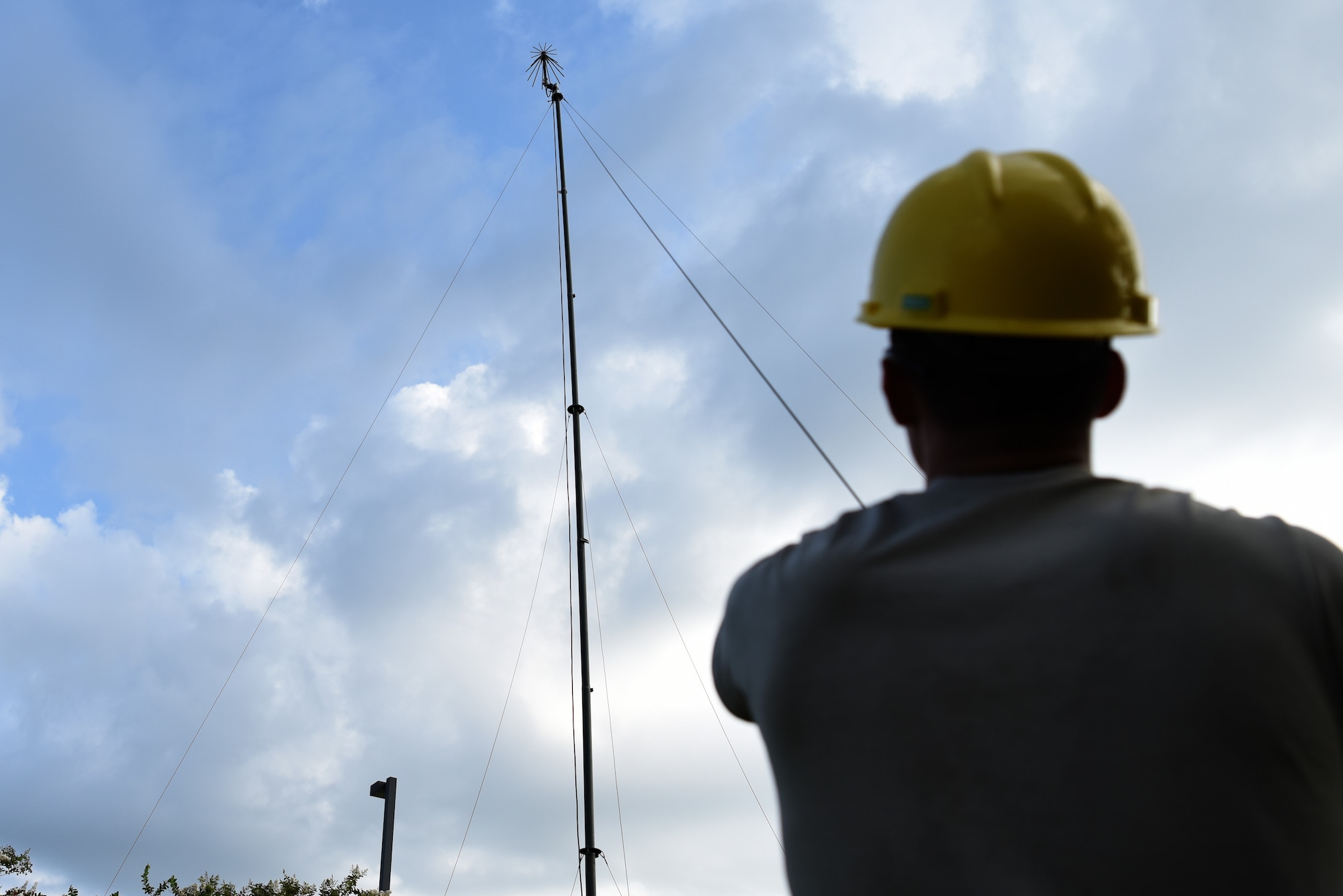 U.S. Air Force Airman 1st Class Branden Wright, 338th Training Squadron Radio Frequency Transmission Systems student, helps set up an ultra high frequency antenna outside of Jones Hall on Keesler Air Force Base, Mississippi, August 12, 2019. The RF Transmission System course is a 653 hour course where students learn line-of-sight communication, high frequency operations, satellite communications and systems and more. (U.S. Air Force photo by Senior Airman Suzie Plotnikov)